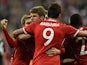 Bayern Munich's Thomas Muller celebrates with teammates after scoring his team's second goal against Manchester United in the Champions League quarter final match on April 9, 2014