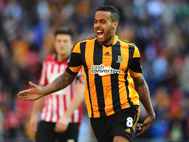 Hull's Tom Huddlestone celebrates after scoring his team's third goal against Sheffield United during the FA Cup semi final match on April 13, 2014