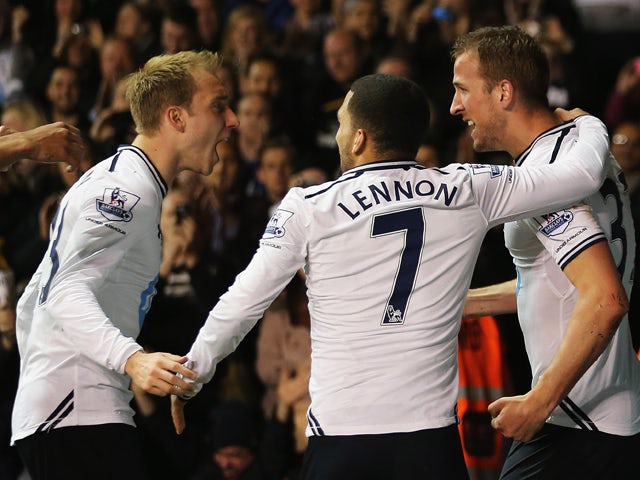 Harry Kane of Tottenham Hotspur celebrates scoring his team's second goal with Christian Eriksen and Aaron Lennon during the Barclays Premier League match between Tottenham Hotspur and Sunderland at White Hart Lane on April 7, 2014