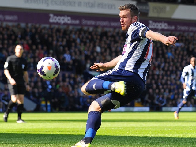 West Bromwich Albion's Irish midfielder Chris Brunt scores the second goal during the English Premier League football match between West Bromwich Albion and Tottenham Hotspur at The Hawthorns in West Bromwich on April 12, 2014