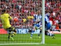 Scott Carson of Wigan Athletic makes a save from Yaya Sanogo of Arsenal during the FA Cup Semi-Final match on April 12, 2014