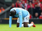 Manchester City midfielder Yaya Toure kneels down in pain after injuring himself during the Premier League match against Liverpool on April 13, 2014