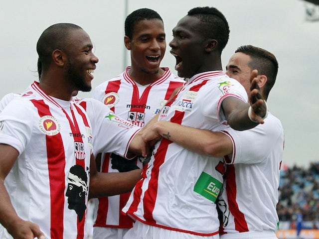 Ajaccio's Guinean forward Aboudacar Camara (C) is congratulated by teammates after scoring a goal during the French L1 football match between Bastia (SCB) and Ajaccio (ACA) on April 20, 2014