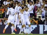 Real's Angel di Maria is congratulated by team mates after scoring the opening goal against Barcelona during the Copa del Rey final match on April 16, 2014