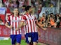 Atletico Madrid's Brazilian-born forward Diego Costa celebrates past Atletico Madrid's Brazilian defender Filipe Luis after scoring during the Spanish league football match Club Atletico de Madrid vs Elche CF at the Vicente Calderon stadium in Madrid on A