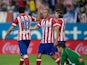 Joao Miranda of Atletico de Madrid claps his hands to celebrate scoring their opening goal with teammate Diego Costa and their teammate Filipe Luis as goalkeeper Manu Herrera of Elche FC reacts defeated during the La Liga match between Club Atletico de Ma