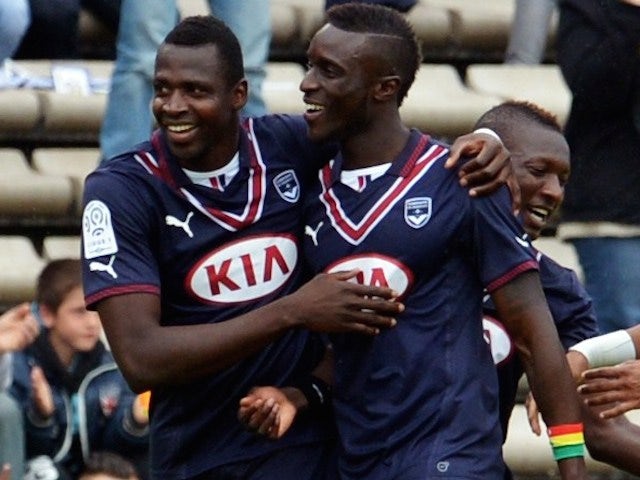 Bordeaux's Malian forward Cheick Diabate (L) celebrates with teammates after scoring a goal during the French L1 football match between FC Girondins de Bordeaux and EA Guinguamp, on April 20, 2014
