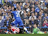 Chelsea's Samuel Eto'o scores his team's first goal beating Sunderland's Italian goalkeeper Vito Mannone during the English Premier League football match between Chelsea and Sunderland at Stamford Bridge in London on April 19, 2014