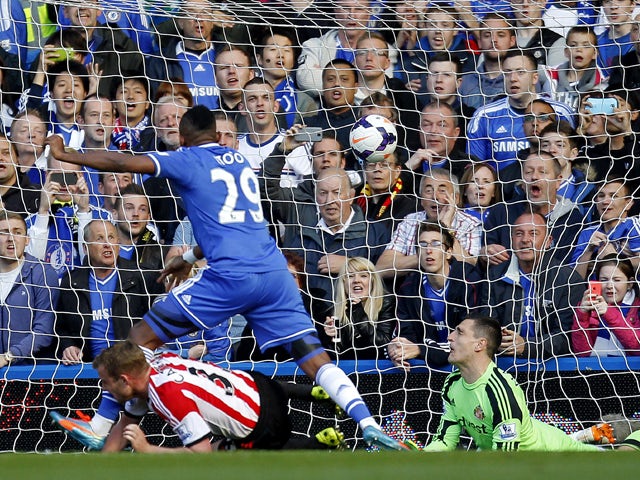 Chelsea's Samuel Eto'o scores his team's first goal beating Sunderland's Italian goalkeeper Vito Mannone during the English Premier League football match between Chelsea and Sunderland at Stamford Bridge in London on April 19, 2014