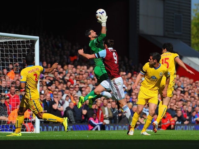 Julian Speroni of Crystal Palace makes a save from Andy Carroll of West Ham during the Barclays Premier League match between West Ham United and Crystal Palace at Boleyn Ground on April 19, 2014