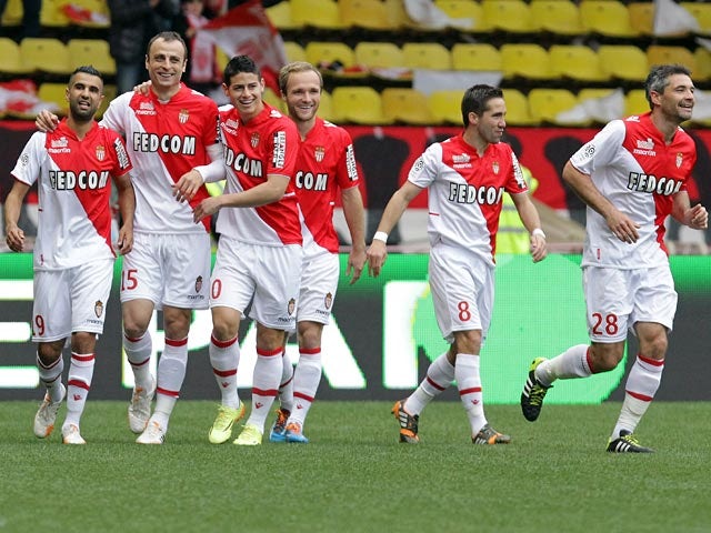 Monaco's Dimitar Berbatov celebrates with teammates after scoring the opening goal against Nice during the Ligue 1 match on April 20, 2014