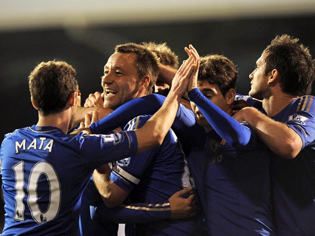 Chelsea's John Terry celebrates with team mates after scoring his team's second goal against Fulham during the Premier League match on April 17, 2013