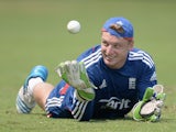 Jos Buttler of England takes part in a wicketkeeping drill during a nets session at Sir Viv Richards Cricket Ground on February 24, 2014