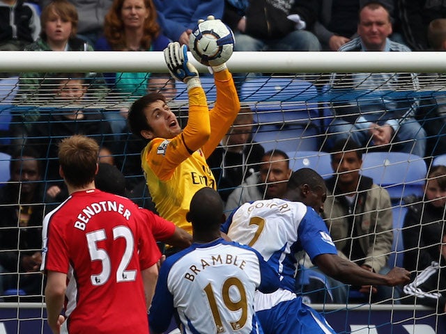 Lukasz Fabianski of Arsenal fails to collect the ball before Titus Bramble of Wigan Athletic scores the equalizing goal during the Barclays Premier League match on April 18, 2010