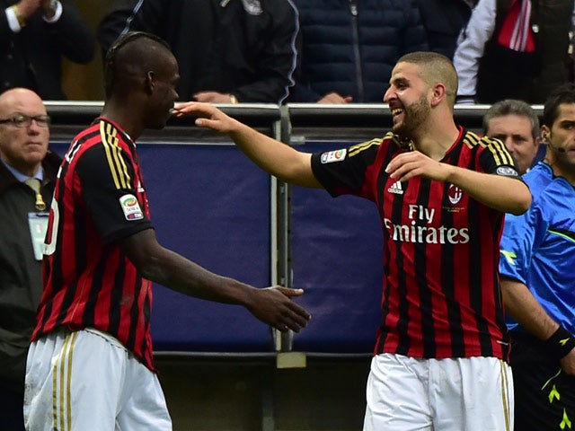 AC Milan's Adel Taarabt celebrates with teammate Mario Balotelli after scoring his team's second goal against Livorno during the Serie A match on April 19, 2014