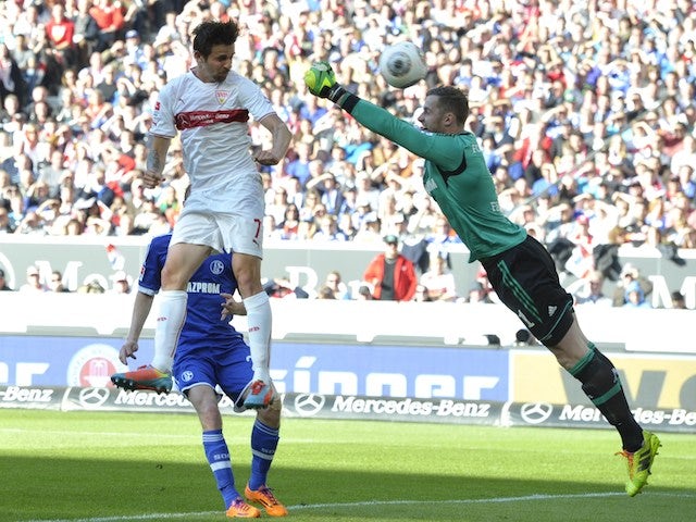 Stuttgart's Austrian forward Martin Harnik (L) scores the opening goal past Schalke's goalkeeper Ralf Faehrmann during the German first division Bundesliga football match on April 20, 2014