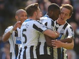 Shola Ameobi of Newcastle United celebrates with team mates after scoring the first goal of the game during the Barclays Premier League fixture between Newcastle United and Swansea City at St. James Park on April 19, 2014