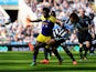 Wilfried Bony of Swansea City is tackled by Fabrizio Coloccini of Newcastle United during the Barclays Premier League match between Newcastle United and Swansea City at St James' Park on April 19, 2014