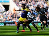 Wilfried Bony of Swansea City is tackled by Fabrizio Coloccini of Newcastle United during the Barclays Premier League match between Newcastle United and Swansea City at St James' Park on April 19, 2014