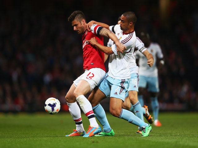 Olivier Giroud of Arsenal battles with Winston Reid of West Ham United during the Barclays Premier League match on April 15, 2014
