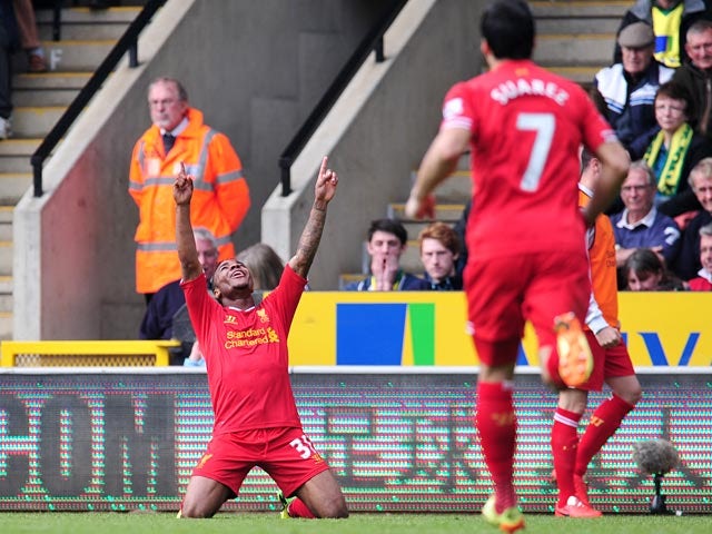 Liverpool's Raheen Sterling celebrates after scoring his team's third goal against Norwich during the Premier League match on April 20, 2014