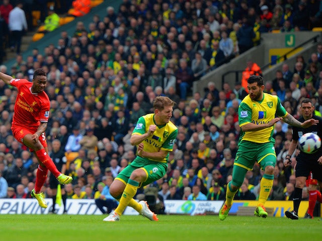 Liverpool's Raheem Sterling fires in the first goal against Norwich City at Carrow Road in the Premier League on April 20, 2014