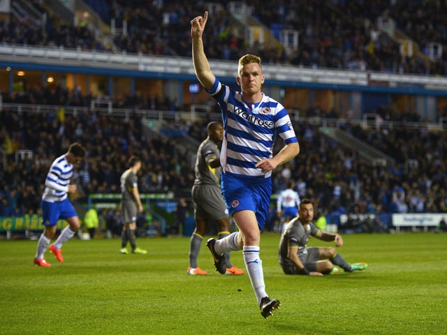 Alex Pearce of Reading celebrates scoring to make it 1-0 during the Sky Bet Championship match between Reading and Leicester City at the Madejski Stadium on April 14, 2014