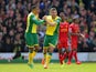 Norwich's Robert Snodgrass celebrates with teammate Martin Olsson after scoring his team's second goal against Liverpool during the Premier League match on April 20, 2014