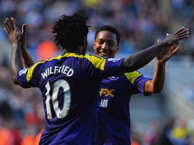 Wilfried Bony of Swansea City celebrates with Jonathan de Guzman of Swansea City as he scores their first goal during the Barclays Premier League match between Newcastle United and Swansea City at St James' Park on April 19, 2014