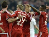 Bayern's Toni Kroos celebrates with team mates after scoring his team's second goal against Kaiserslautern during the DFB-Pokal semi-final match on April 16, 2014