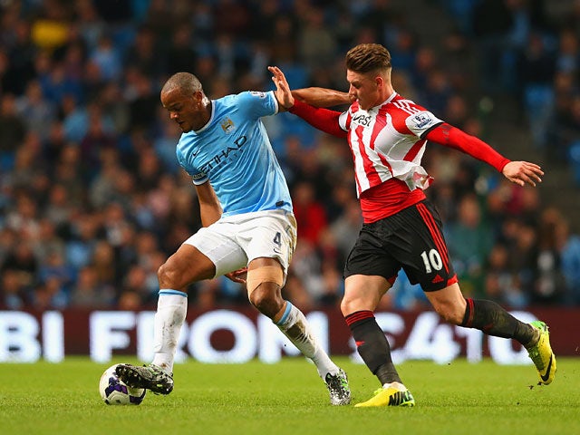 Sunderland's Connor Wickham and Manchester City's Vincent Kompany in action during the Premier League match on April 16, 2014