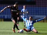 James Perch of Wigan Athletic tackles Jobi McAnuff of Reading during the Sky Bet Championship match between Wigan Athletic and Reading at DW Stadium on April 18, 2014