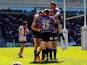 Joe Burgess of Wigan celebrates with team-mates after scoring a try during the Super League match between St Helens and Wigan Warriors at Langtree Park on April 18, 2014