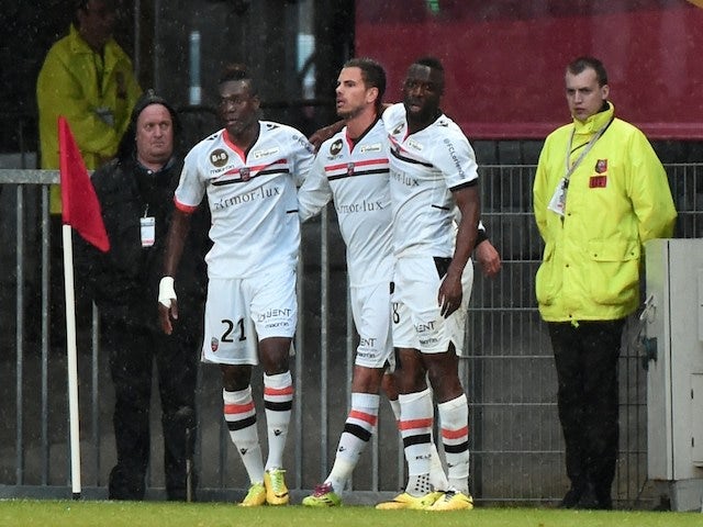 Lorient's French midfielder Alain Traore (L) celebrates with teammates after scoring a goal during the French L1 football match against Rennes on April 26, 2014