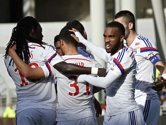 Lyon's French forward Alexandre Lacazette (R) celebrates with teammates after scoring during the French Ligue 1 football match against SC Bastia on April 27, 2014