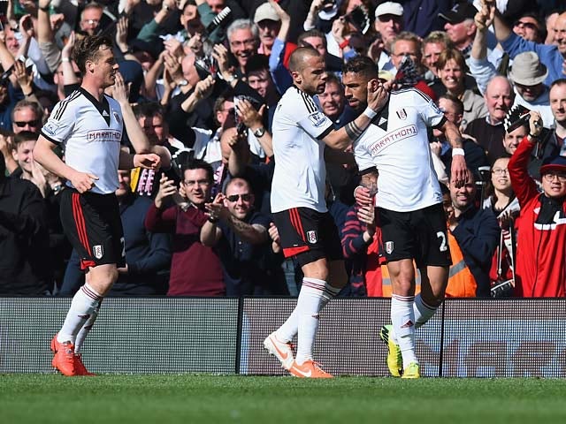Fulham's Ashkan Dejagah celebrates with teammates after scoring the opening goal against Hull during the Premier League match on April 26, 2014