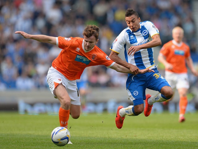Andrew Halliday of Blackpool holds off a challenge from Jesse Lingard of Brighton during the Sky Bet Championship match between Brighton & Hove Albion and Blackpool at Amex Stadium on April 21, 2014