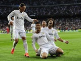 Real Madrid's Portuguese forward Cristiano Ronaldo (C) celebrates with Real Madrid's Brazilian defender Marcelo (R) and Real Madrid's German midfielder Mesut Ozil after scoring against Bayern on April 25, 2012