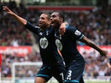 Tottenham's Danny Rose celebrates with teammate Aaron Lennon after scoring the opening goal against Stoke during the Premier League match on April 26, 2014
