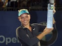 Donna Vekic of Croatia poses with her trophy after defeating Dominika Cibulkova of Slovakia in the singles final during day three of the Malaysian Tennis Open at The Royal Selangor Golf Club on April 20, 2014
