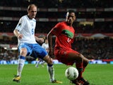 Elvir Rahimic of Bosnia attempts to win possession from Portugal winger Nani on November 11, 2011.