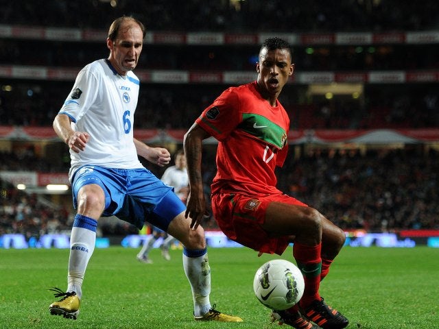 Elvir Rahimic of Bosnia attempts to win possession from Portugal winger Nani on November 11, 2011.