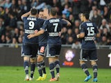 Marseille's Florian Thauvin celebrates with teammates after scoring the opening goal against Nantes during the Ligue 1 match on April 25, 2014