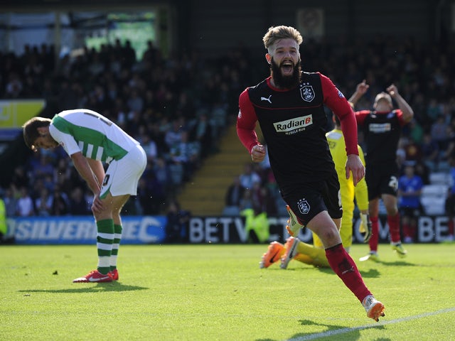 Adam Clayton of Huddersfield Town celebrates scoring his side's second goal during the Sky Bet Championship match between Yeovil Town and Huddersfield Town at Huish Park on April 21, 2014