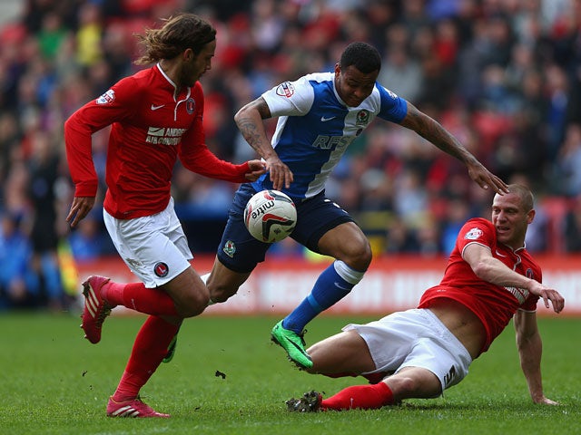 Blackburn's Joshua King is challenged by Charlton's Diego Poyet and Michael Morrison during the Championship match on April 26, 2014