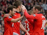 Manchester United players Juan Mata (L) and Wayne Rooney (R) celebrate after Mata scored the third goal against Norwich City at Old Trafford on April 26, 2014