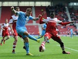 Middlesbrough's Kenneth Omeruo and Barnsley's Marcus Pederson in action during the Championship match on April 26, 2014