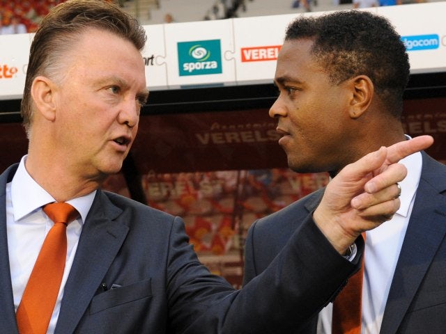 Louis van Gaal and Patrick Kluivert stand on the touchline before a Netherlands match on November 14, 2012.