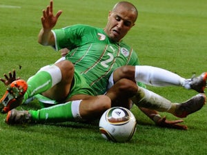 Algeria defender Madjid Bougherra performs a slide tackle against England on June 18, 2010.