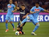 Inter Milan's Croatian midfielder Mateo Kovacic (L) fights for the ball with Napoli's Uruguayan defender Angel Miguel Britos during the Italian Seria A football match on April 26, 2014